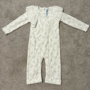 6-9 month bodysuit. White with gray flowers, ruffle detail on front